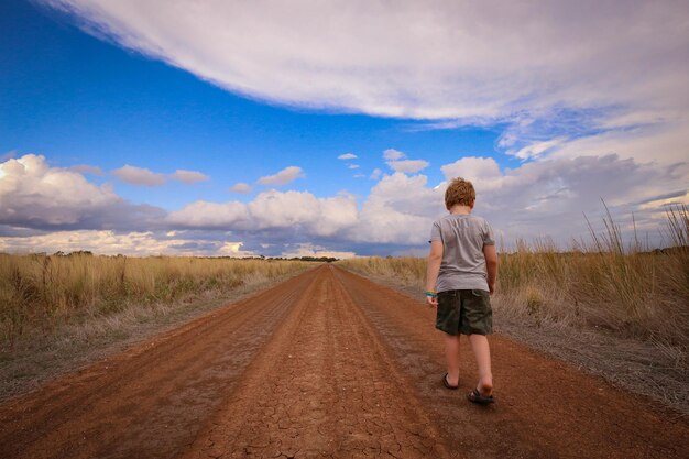 Beautiful shot of a boy walking in a rural environment