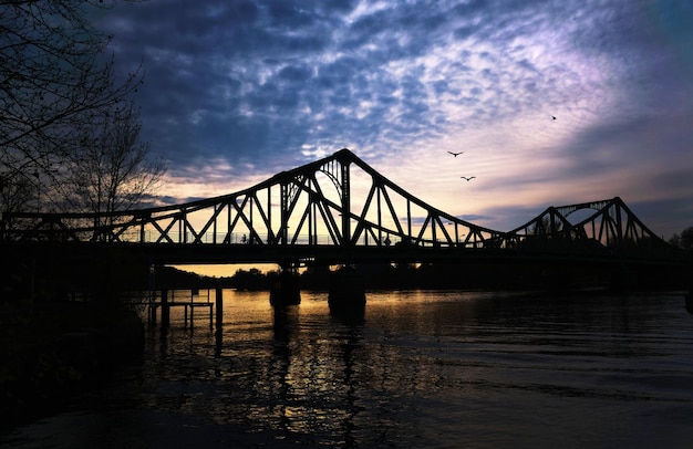 Free photo beautiful shot of the bridge over the river during sunrise