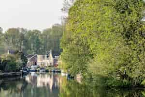 Free photo beautiful shot of a clear river surrounded with houses and trees