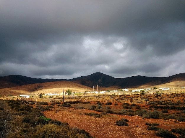 Beautiful shot of a dry valley with hills in shadows in the in Fuerteventura, Spain.