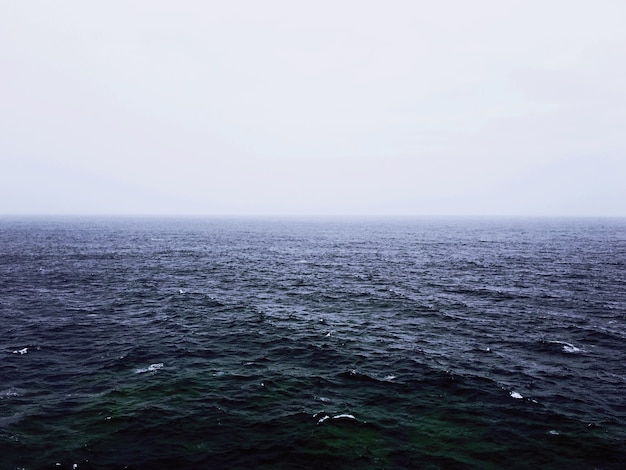 A beautiful shot of an empty sea with a foggy background