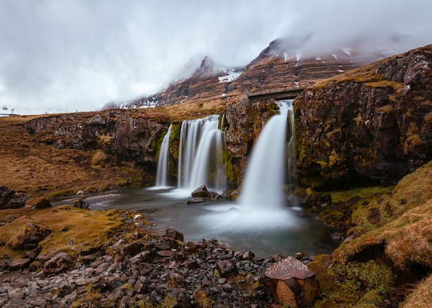 Free Photo beautiful shot of a field with waterfalls on hills