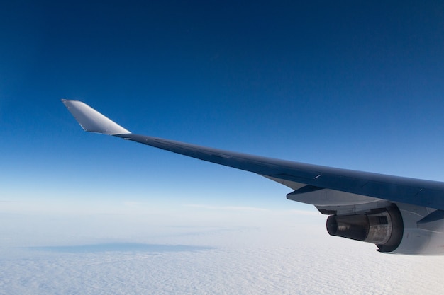 Free Photo beautiful shot from an airplane window of the wings over the clouds