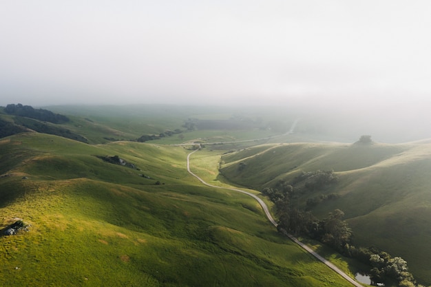 Free photo beautiful shot of green hills under clear blue sky