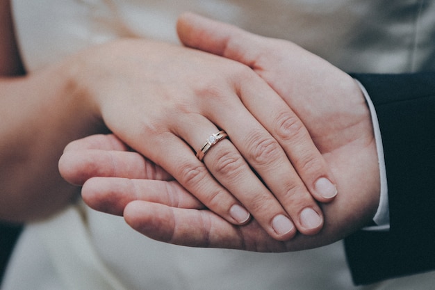 Free photo beautiful shot of the hands of a newly married couple