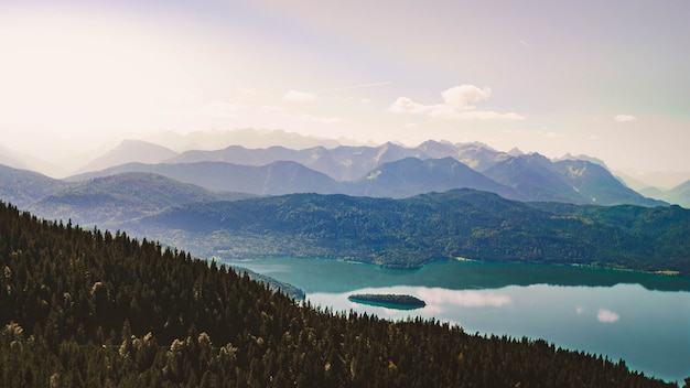 Free Photo beautiful shot of a high altitude lake surrounded by green mountains with sky