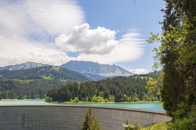 Beautiful shot of Lac de l'Hongrin dam with mountains under a clear sky - perfect for travel blog