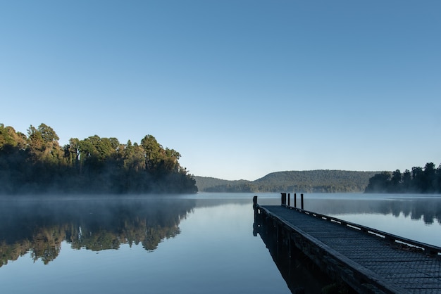 Beautiful shot of Lake Mapourika in New Zealand surrounded by a green scenery