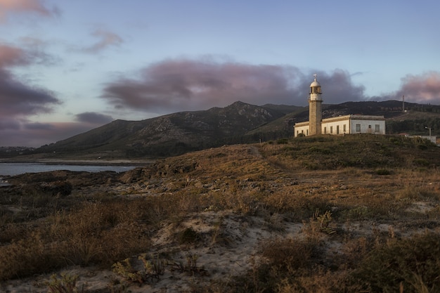 Beautiful shot of the Larino Lighthouse on a hill In Galicia Spain