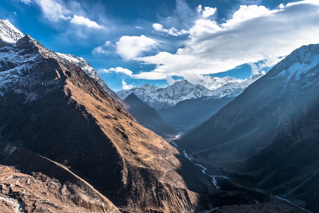 Beautiful shot of a mountainous area in winter and the cloudy sky above