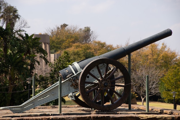 Beautiful shot of an old cannon in a park being displayed on a sunny day