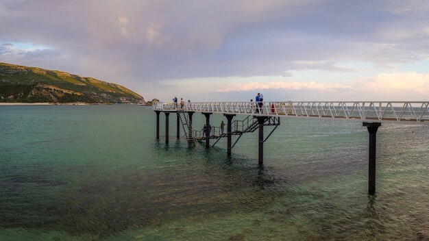 Beautiful shot of people on the harbor in Parque Natural da Arrábida, Casal, Portugal