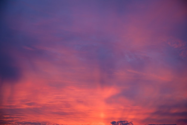 Beautiful shot of pink clouds in a clear blue sky with a scenery of sunrise