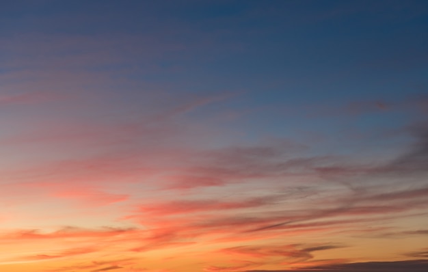 Free photo beautiful shot of pink clouds in a clear blue sky with a scenery of sunrise