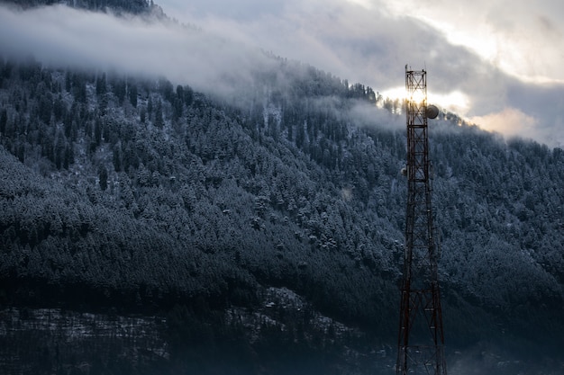 Beautiful shot of a radio tower on a snowy forest background