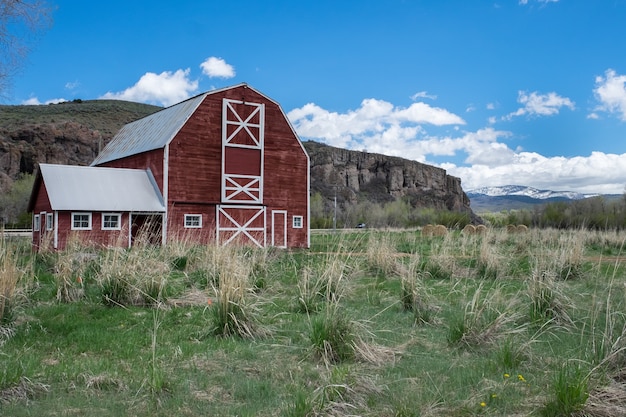 Free Photo beautiful shot of the red wooden barnyard in the field