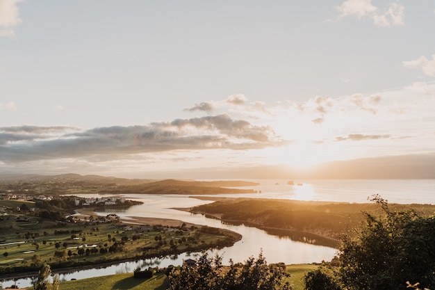 Beautiful shot of a river flowing through nature and the sun shining