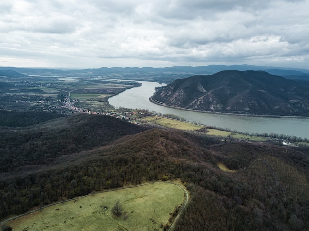 Beautiful shot of a river between hills under the cloudy sky