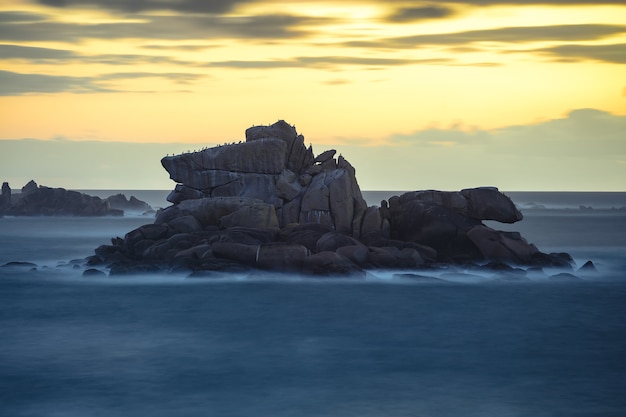 Free Photo beautiful shot of rocks on a seashore during sunset