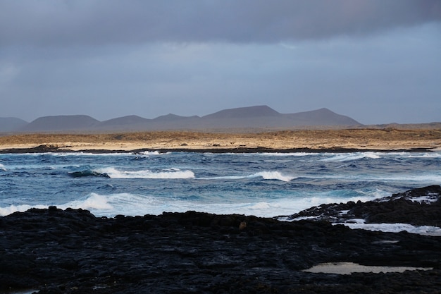 Beautiful shot of the rocky beach and mountains in Fuerteventura, Spain