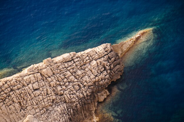 Beautiful shot of rocky cliffs of the sea on a sunny day