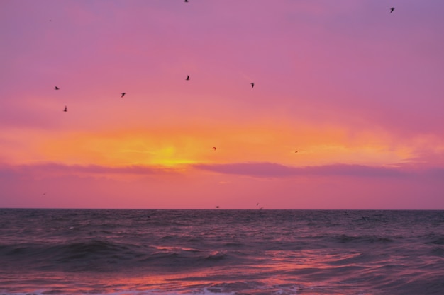 Beautiful shot of the sea with the amazing shining sun on the horizon during sunset