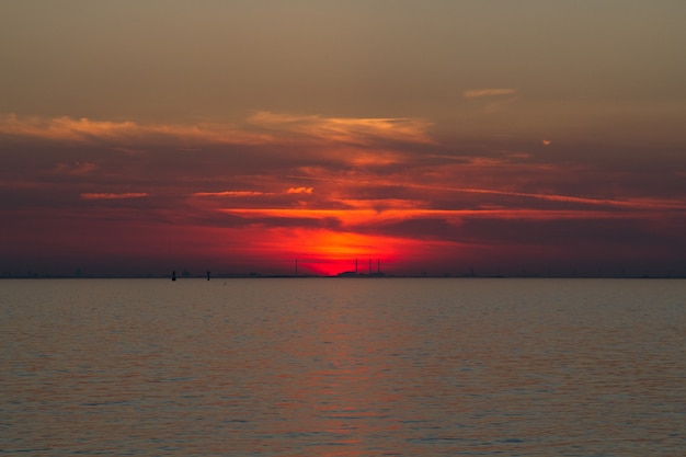 Beautiful shot of the sea with a red sky in the distance