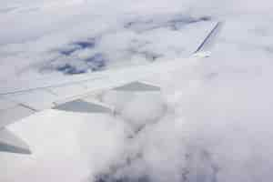 Free photo beautiful shot of the sky full of clouds and an airplane wing from the plane window