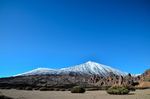 Free Photo beautiful shot of a snowy mountain with a clear blue sky