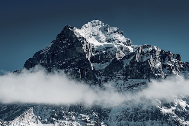 Free photo beautiful shot of the snowy mountains surrounded by clouds