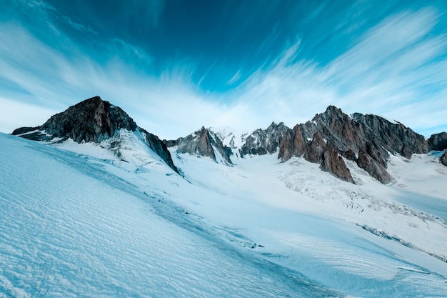 Beautiful shot of snowy mountains with a dark blue sky