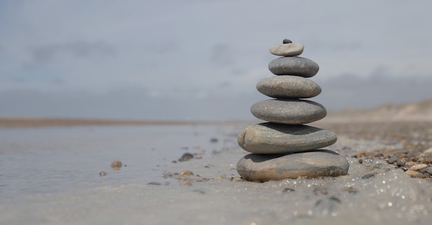 Free photo beautiful shot of a stack of rocks on the beach - business stability concept