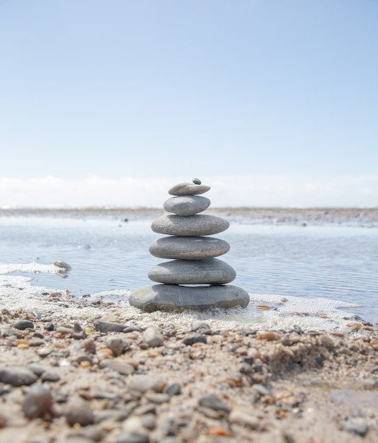 Free photo beautiful shot of a stack of rocks on the beach - business stability concept