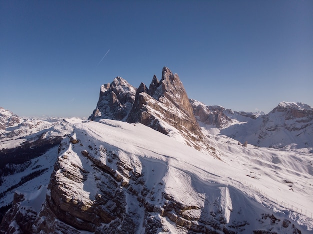 Free photo beautiful shot of a steep mountain covered with white snow during winter