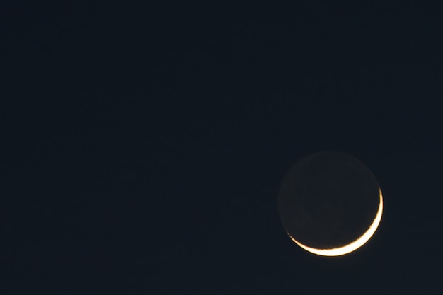 Beautiful shot of the sun going behind the moon with a dark wall