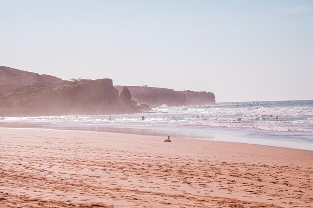 Beautiful shot of tourists swimming in the ocean on a sunny summer day