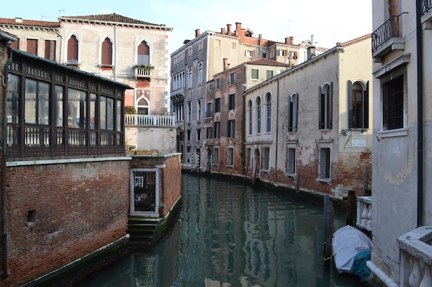 Free Photo beautiful shot of water in the middle of buildings under a blue sky