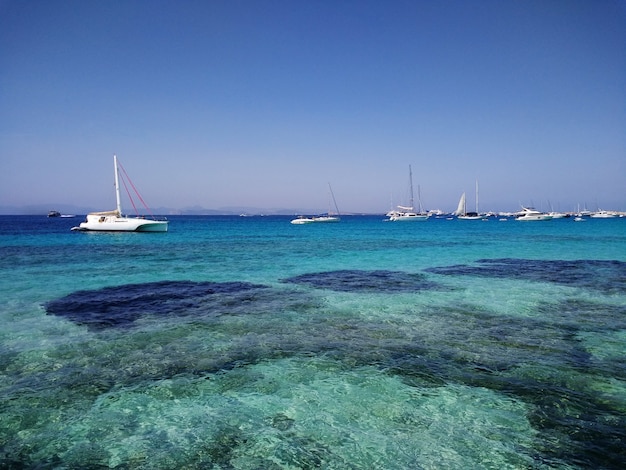 Free photo beautiful shot of white boats in coast next to formentera, spain