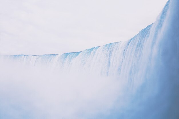 Free Photo beautiful shot of a wide large waterfall with amazing clear sky in the background