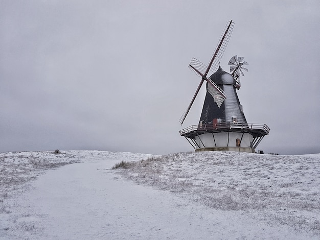 Beautiful shot of a windmill in the middle of a winter field