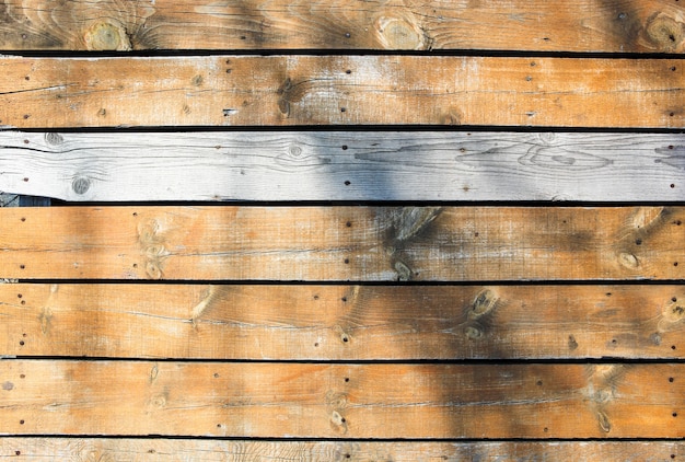 Free Photo beautiful shot of a wooden wall with a shadow on the surface