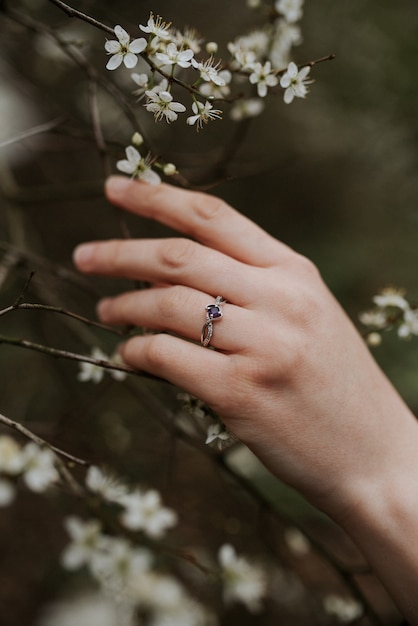 Free Photo beautiful silver ring with a purple diamond on a soft female hand