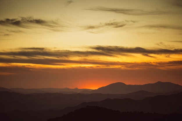 Free Photo beautiful sky on yellow shades with mountains