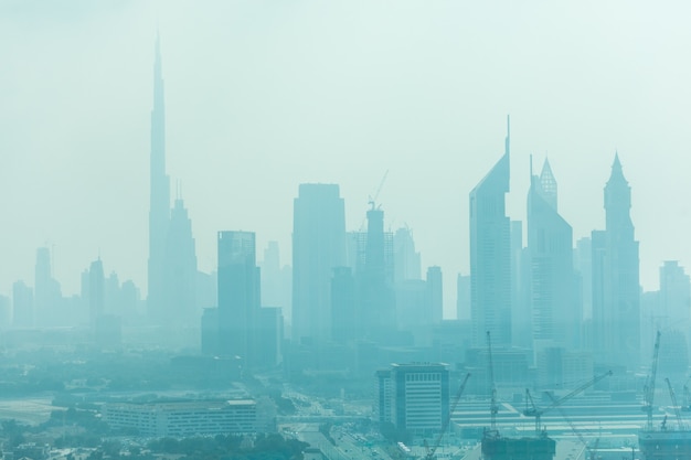 Free photo beautiful skyline of dubai surrounded by sand dust at day light