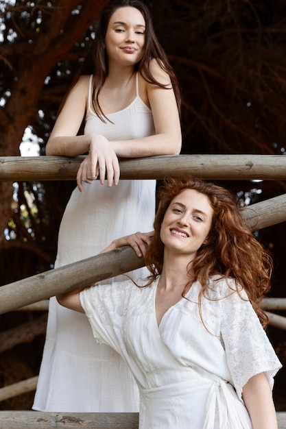 Free photo beautiful smiley women posing together in nature