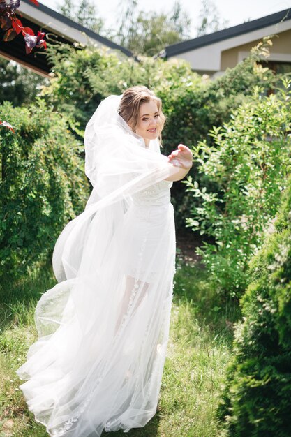 Beautiful and smiling bride in the garden