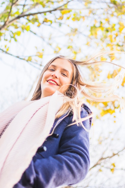 Free photo beautiful smiling female looking from above at autumn sky surface