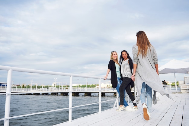 Free Photo beautiful smiling girls posing photographer. positive emotions.