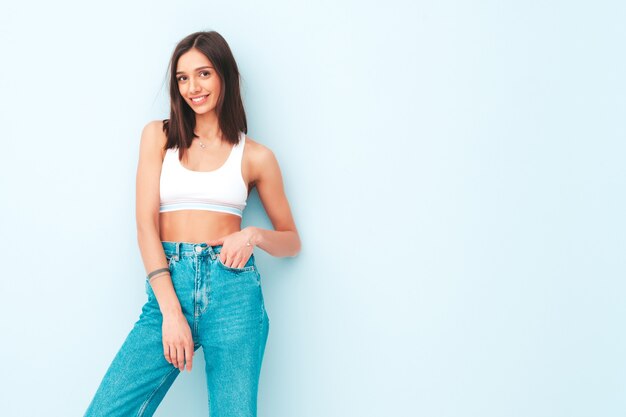 Beautiful smiling woman dressed in white jersey top shirt and jeans