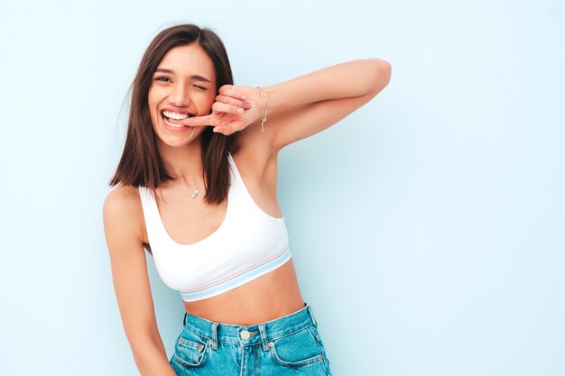 Beautiful smiling woman dressed in white jersey top shirt and jeans. 